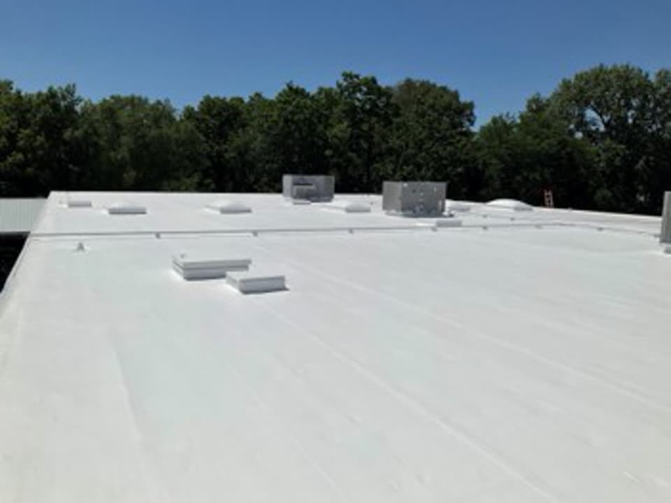After: the same Illinois EPDM flat roof restored with a bright white Conklin reflective coating system