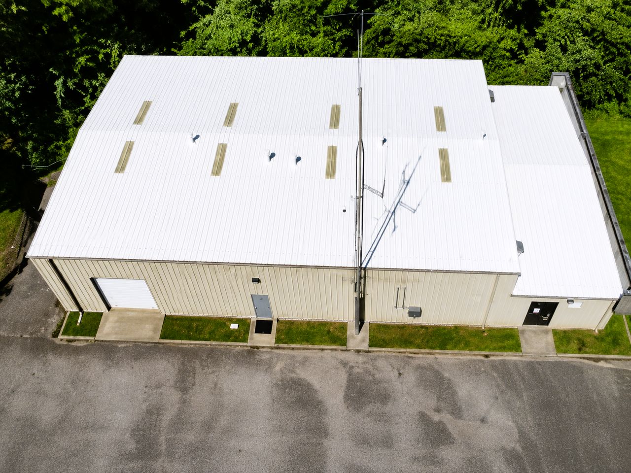 Leaking metal commercial roof in Bloomington, Indiana sealed and coated with a Conklin white reflective system
