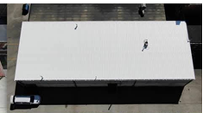 After: the same commercial building with a bright white Conklin reflective roof coating installed